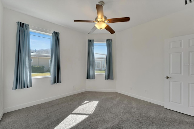 carpeted empty room featuring ceiling fan