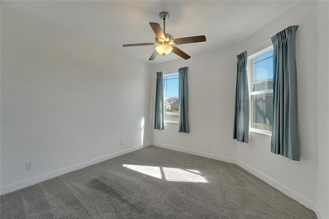 spare room with carpet flooring, ceiling fan, and plenty of natural light