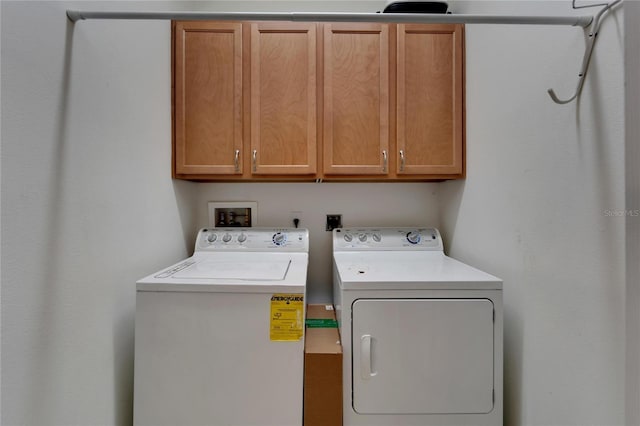 washroom featuring washer and dryer and cabinets