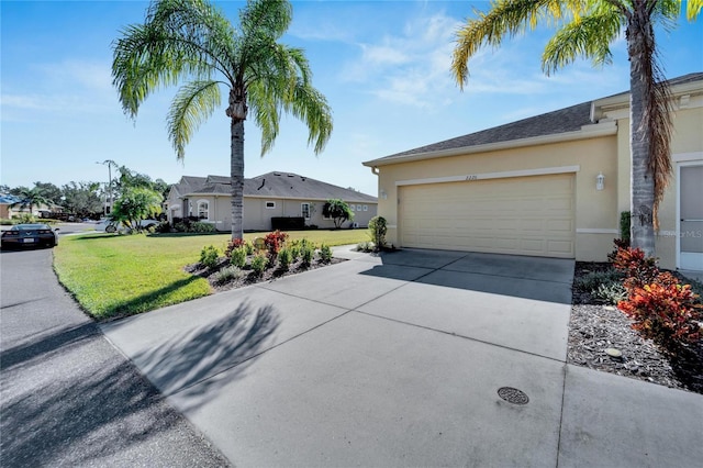 ranch-style house with a garage and a front lawn