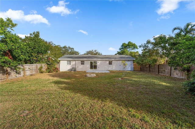 rear view of property featuring a lawn