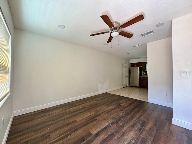 unfurnished room featuring ceiling fan, a healthy amount of sunlight, and light wood-type flooring