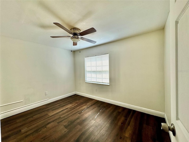 empty room with dark hardwood / wood-style floors and ceiling fan