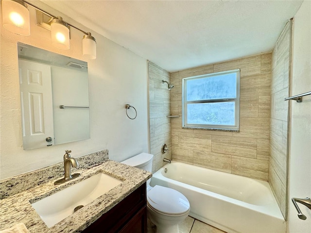 full bathroom with tile patterned floors, vanity, tiled shower / bath combo, a textured ceiling, and toilet