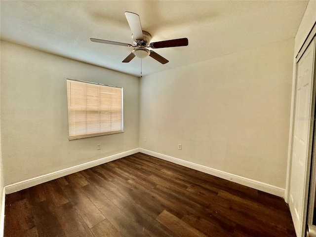 unfurnished room featuring ceiling fan and dark hardwood / wood-style flooring