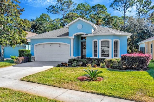 single story home with a garage and a front lawn