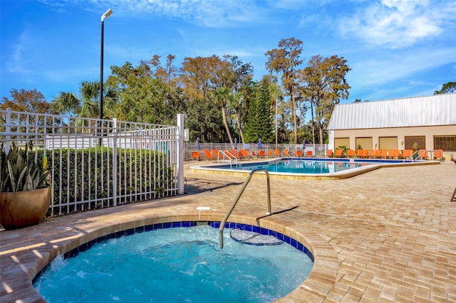 view of pool featuring a community hot tub and a patio