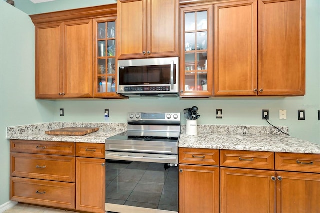 kitchen featuring light stone counters and stainless steel appliances