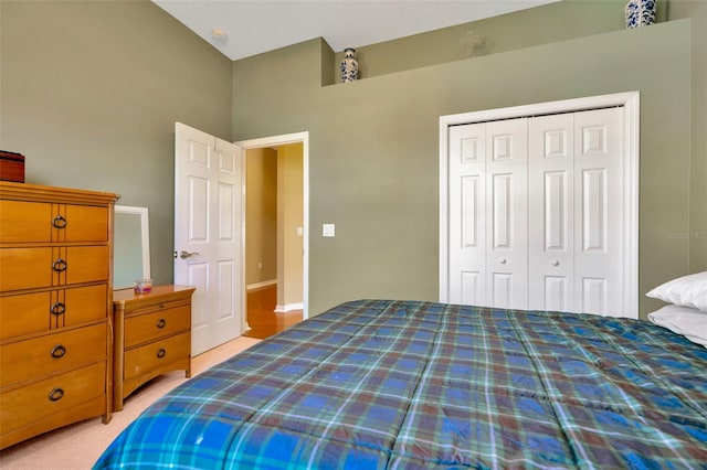 bedroom with light colored carpet and a closet