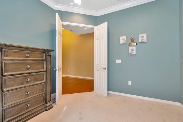 unfurnished bedroom with ornamental molding and light carpet