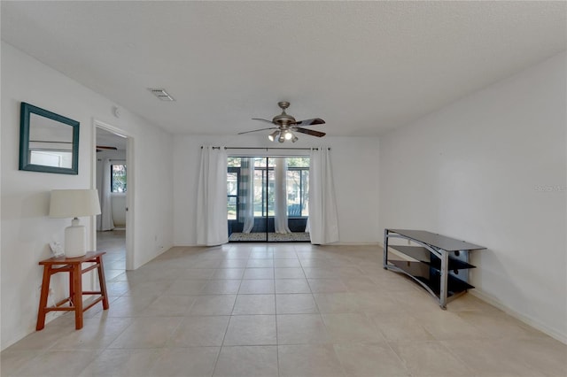 unfurnished room with ceiling fan, french doors, and light tile patterned floors