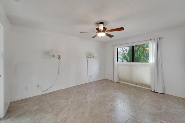 spare room with ceiling fan and a textured ceiling