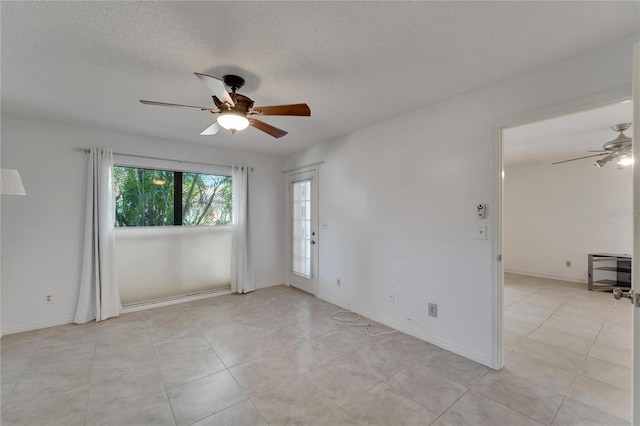 spare room with ceiling fan and a textured ceiling