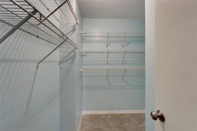 spacious closet with tile patterned flooring