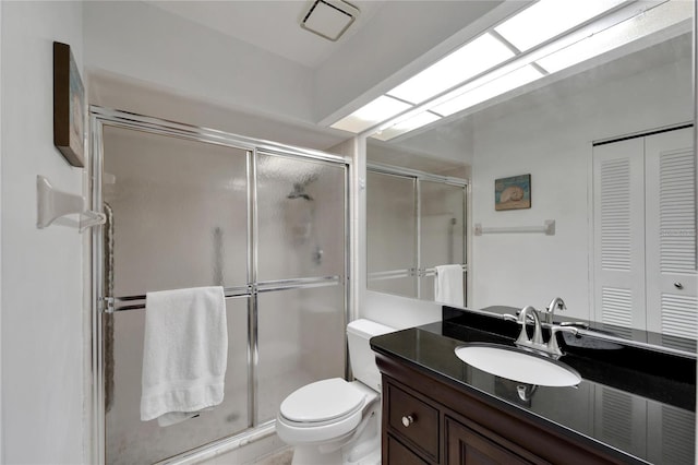 bathroom with vanity, toilet, and walk in shower