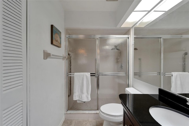 bathroom with tile patterned floors, toilet, an enclosed shower, and vanity