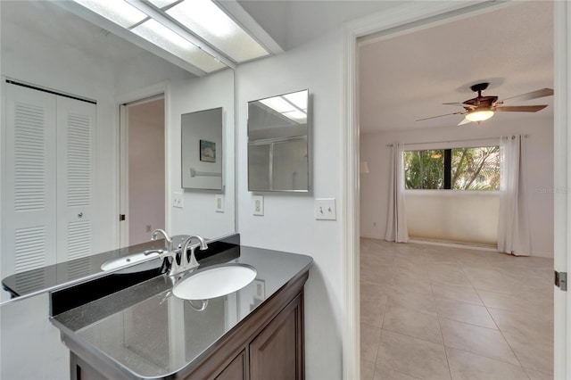 bathroom with tile patterned floors, ceiling fan, and vanity