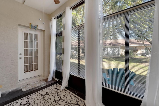 doorway featuring hardwood / wood-style floors and ceiling fan