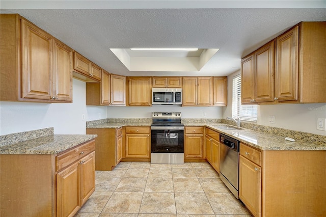 11339 Gulfstream Blvd, Port Charlotte, FL 33981 - kitchen with stainless steel appliances, light stone countertops, a raised ceiling, and brown cabinets