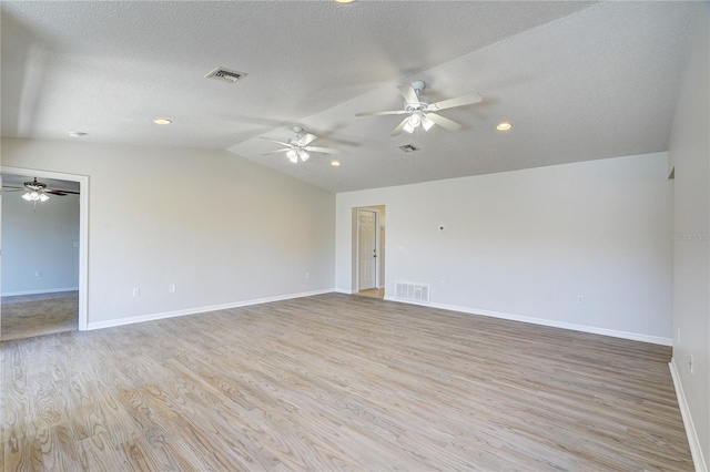 11339 Gulfstream Blvd, Port Charlotte, FL 33981 - unfurnished room featuring lofted ceiling, light wood-style floors, a ceiling fan, and a textured ceiling