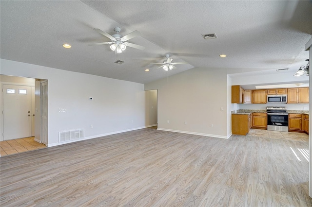 11339 Gulfstream Blvd, Port Charlotte, FL 33981 - unfurnished living room featuring a ceiling fan, light wood-style floors, lofted ceiling, a textured ceiling, and recessed lighting