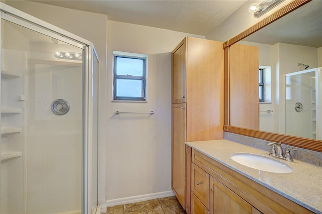 bathroom featuring a textured ceiling, vanity, and an enclosed shower