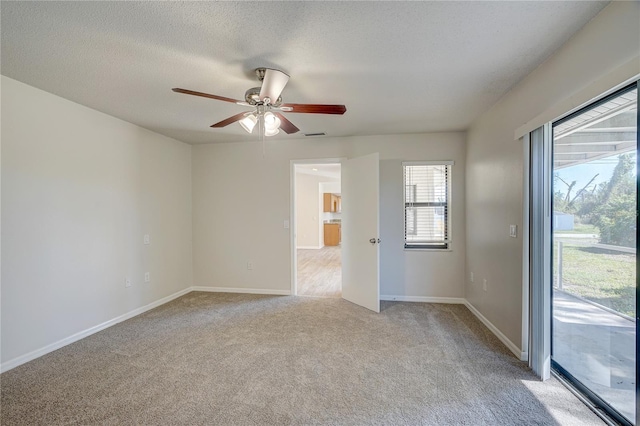 11339 Gulfstream Blvd, Port Charlotte, FL 33981 - empty room featuring light colored carpet, a ceiling fan, and a textured ceiling