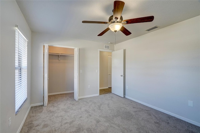 11339 Gulfstream Blvd, Port Charlotte, FL 33981 - unfurnished bedroom with carpet, a closet, and a ceiling fan
