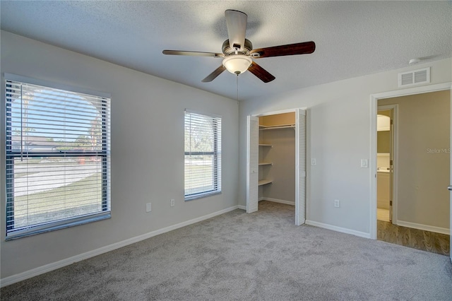 11339 Gulfstream Blvd, Port Charlotte, FL 33981 - unfurnished bedroom featuring carpet flooring, a ceiling fan, a textured ceiling, and a closet