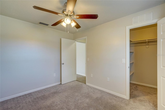 11339 Gulfstream Blvd, Port Charlotte, FL 33981 - unfurnished bedroom featuring carpet, a spacious closet, ceiling fan, and a closet