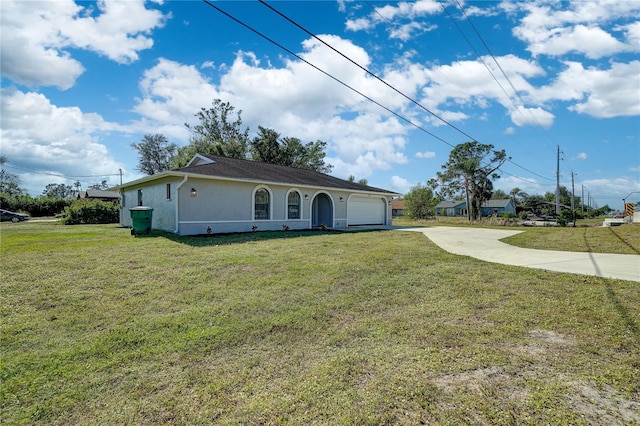 view of front facade with a front yard and a garage