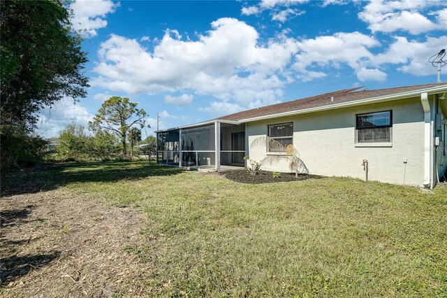 11339 Gulfstream Blvd, Port Charlotte, FL 33981 - view of grassy yard featuring a sunroom