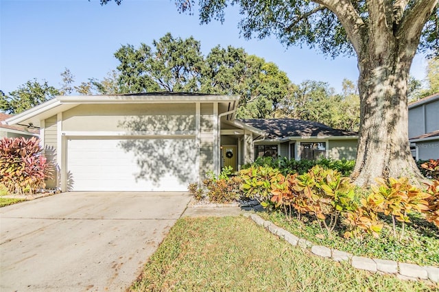 14631 Village Glen Cir, Tampa, FL 33618 - mid-century modern home featuring an attached garage and concrete driveway