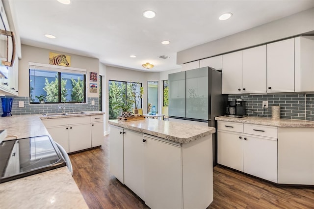 14631 Village Glen Cir, Tampa, FL 33618 - kitchen featuring a center island, stainless steel fridge, backsplash, a sink, and dark wood-style floors