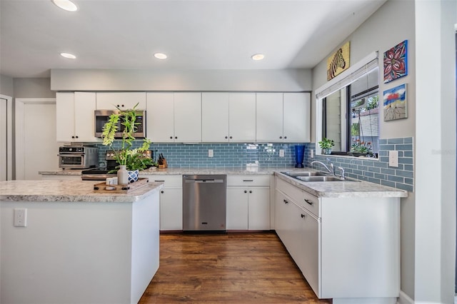14631 Village Glen Cir, Tampa, FL 33618 - kitchen with stainless steel appliances, a sink, light countertops, tasteful backsplash, and white cabinetry