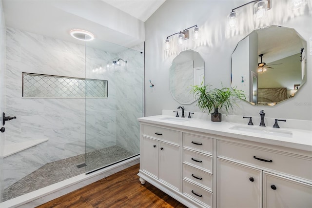 14631 Village Glen Cir, Tampa, FL 33618 - bathroom featuring a marble finish shower, double vanity, wood finished floors, and a ceiling fan