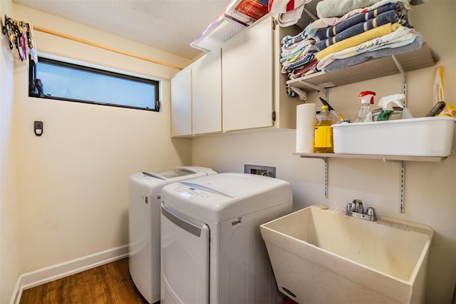 laundry room with separate washer and dryer, sink, cabinets, and dark wood-type flooring