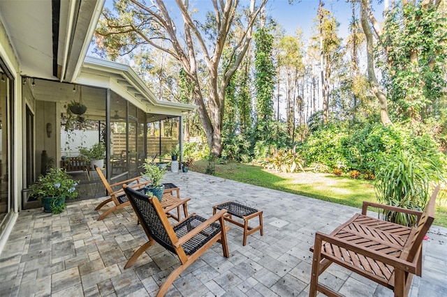 view of patio with a sunroom