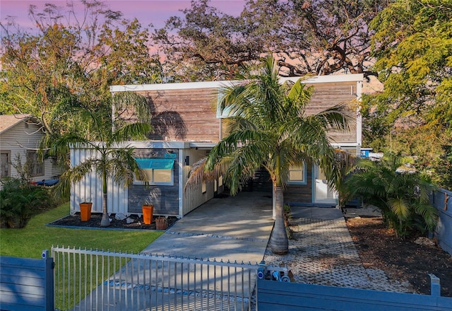 view of front of house featuring a lawn and a carport