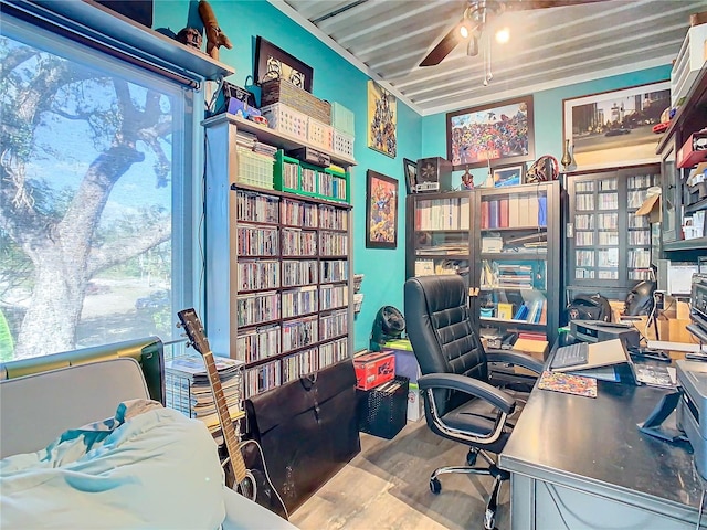 home office with hardwood / wood-style flooring and ceiling fan