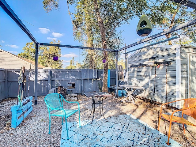 view of patio featuring a storage unit