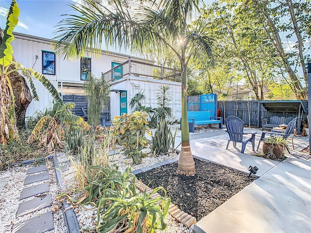 view of front of property with a patio and a balcony