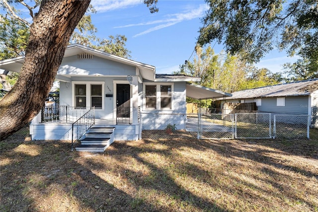 bungalow-style home featuring a porch and a carport