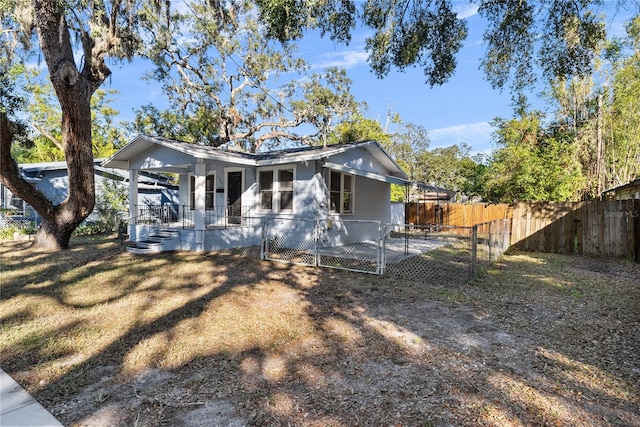 rear view of house featuring a porch