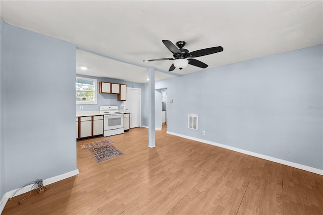 unfurnished living room with ceiling fan and light wood-type flooring