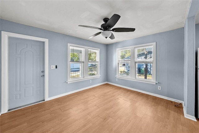 foyer with ceiling fan and light wood-type flooring