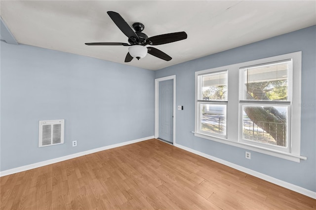 unfurnished room with light wood-type flooring and ceiling fan