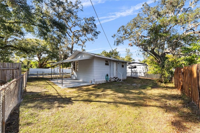 rear view of house with a patio area and a yard