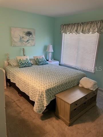 bedroom featuring light colored carpet