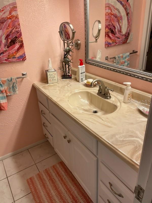 bathroom with tile patterned flooring and vanity